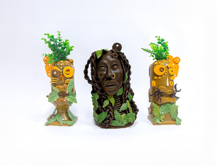 3 ceramic sculptures with intricate details of geometric shapes and African patterns.
